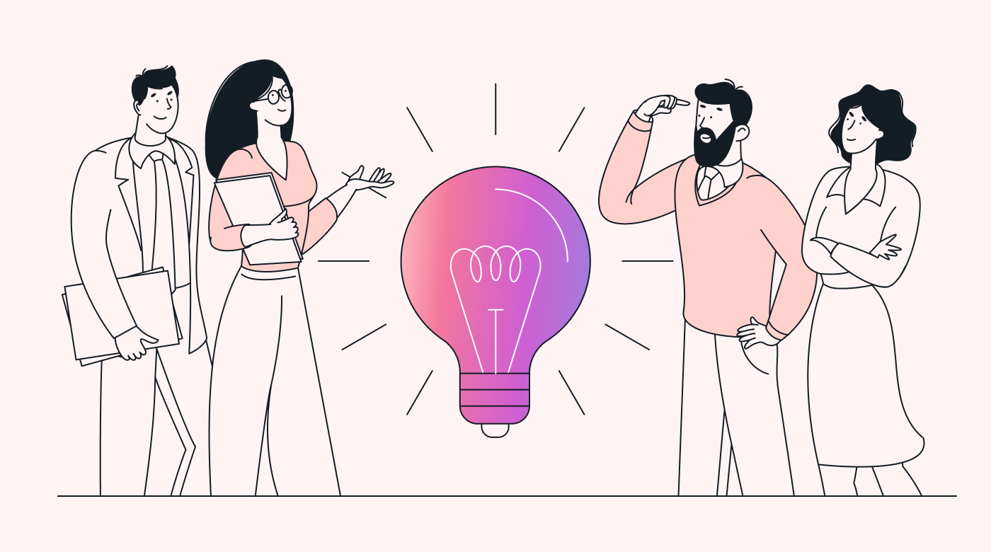 A team discussing ideas around a giant pink light bulb