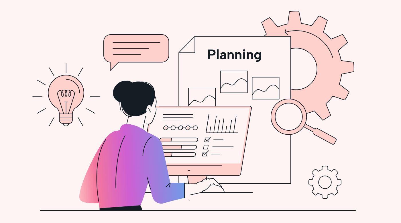 A person working at a laptop with planning documents