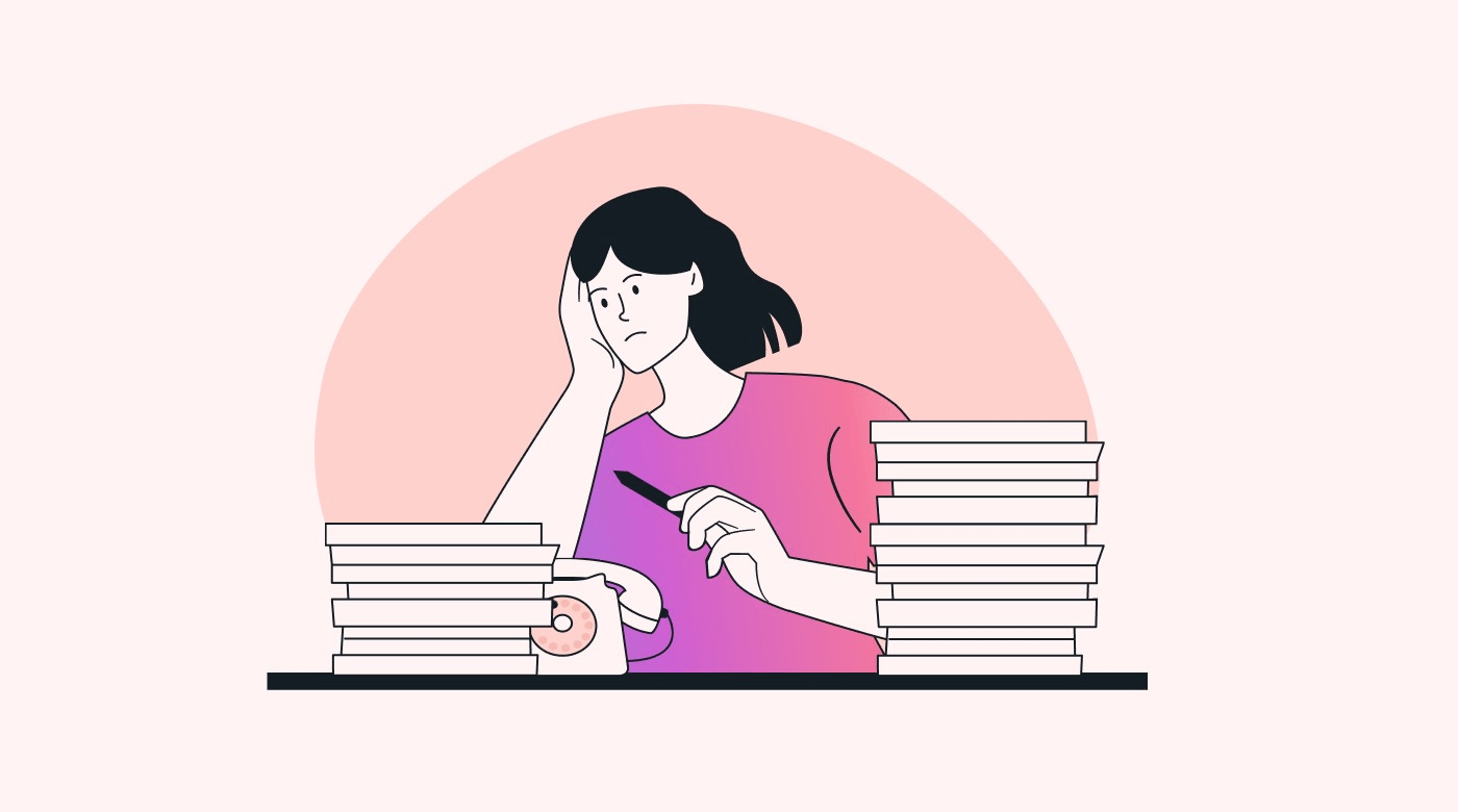 A person with a pile of papers on a desk