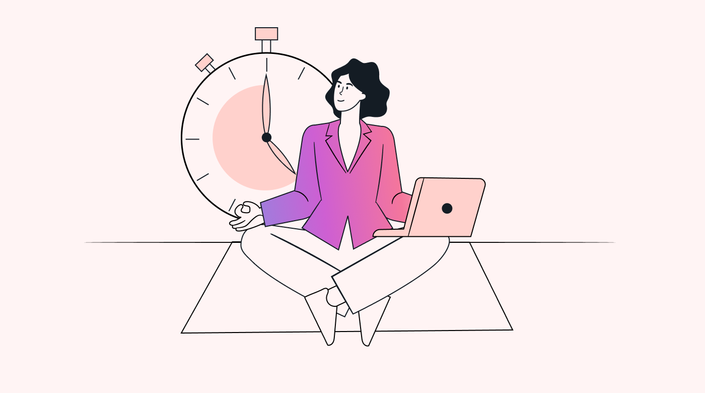 A person sat on a mat in a yoga pose, with a laptop on their lap and a large clock in the background