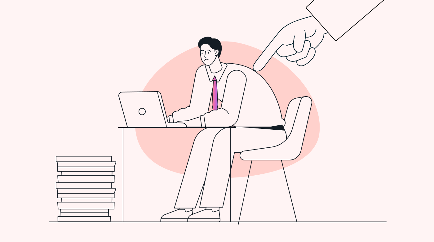 Hand pressing an employee into a desk from above